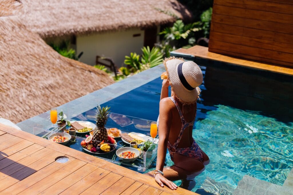 woman-in-bikini-and-straw-hat-with-floating-breakfast-at-amazing-luxury-bali-style-villa