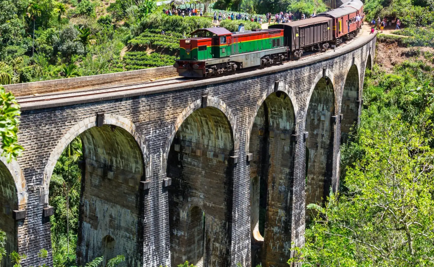 Train crossing the Nine Arch Bridge surrounded by jungle near Ella, Sri Lanka